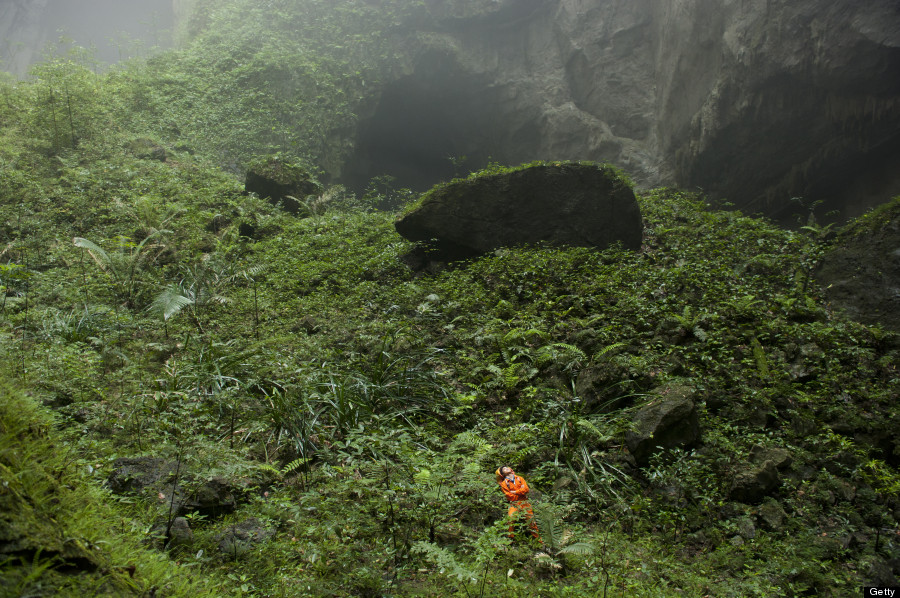 VIETNAM - APRIL 30: A Hang Son Doong explorer navigates an plant-covered cavescape. Phong Nha Ke Bang National Park, Vietnam. (Photo by Carsten Peter/National Geographic/Getty Images)
